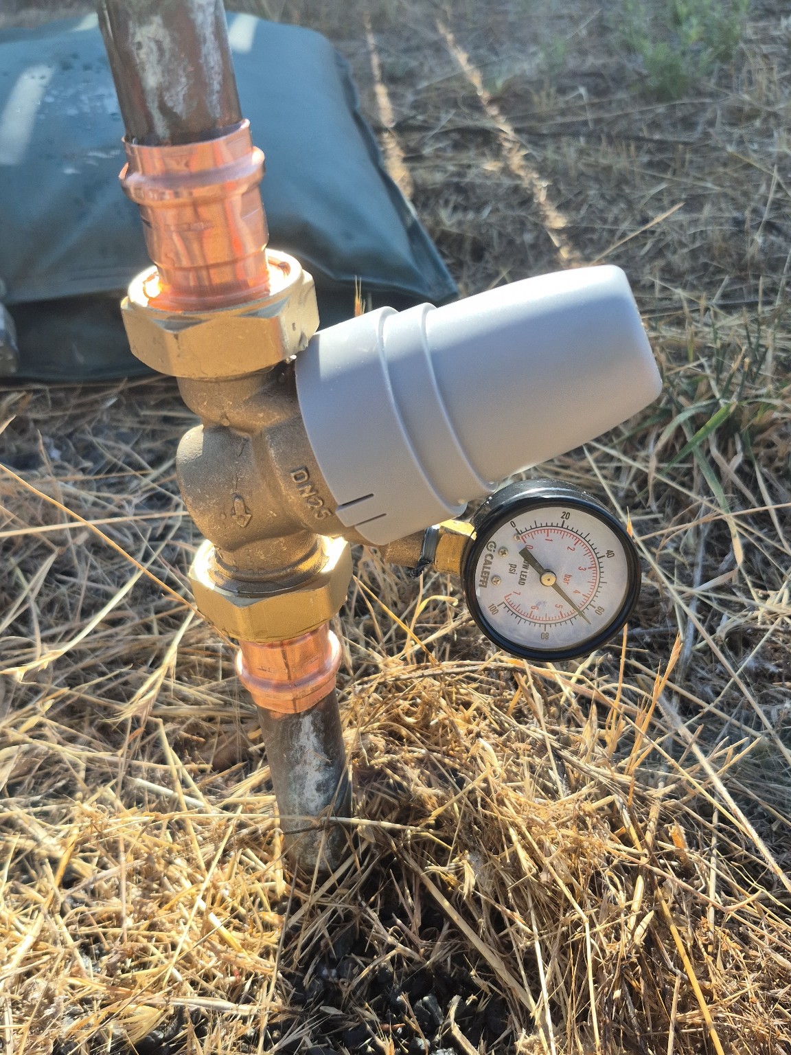Copper water service pressure regulator and gauge installed by Pro-Tech Plumbing