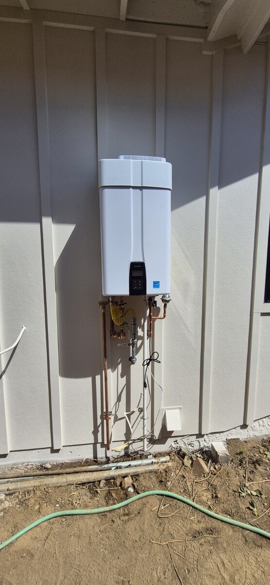 Outdoor tankless water heater installation by Pro-Tech Plumbing